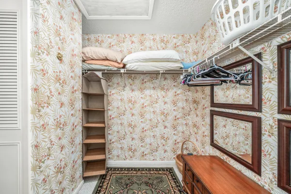 a view of a hallway with wooden floor and a fireplace