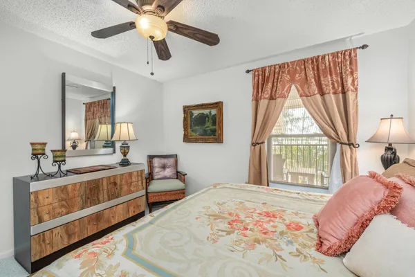 a bedroom with a large bed and a large window