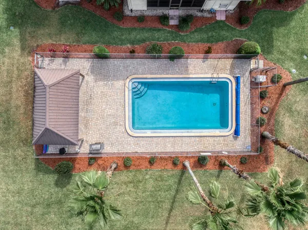 an aerial view of a house with a yard basket ball court and outdoor seating