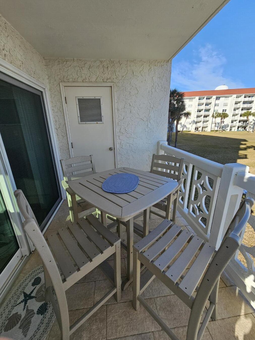 909 Santa Rosa Boulevard, Unit 229 Fort Walton Beach, FL 32548 - Photo 12 of 36 a view of a balcony with a table and chairs