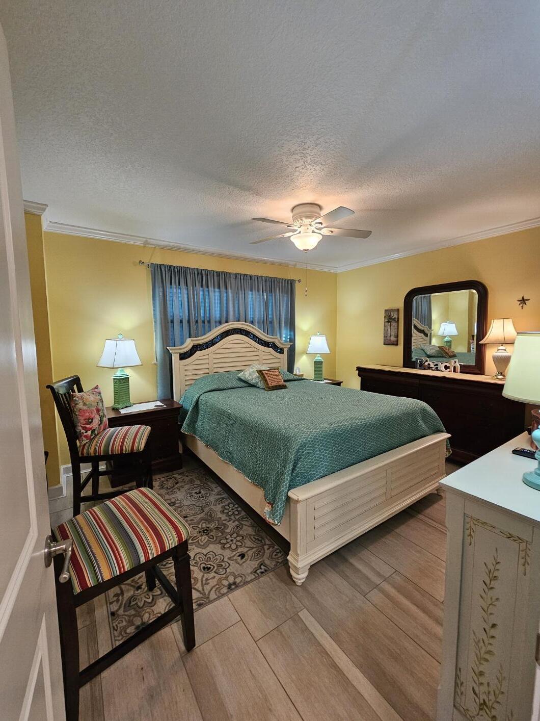909 Santa Rosa Boulevard, Unit 229 Fort Walton Beach, FL 32548 - Photo 19 of 36 a bedroom with a bed and wooden floor