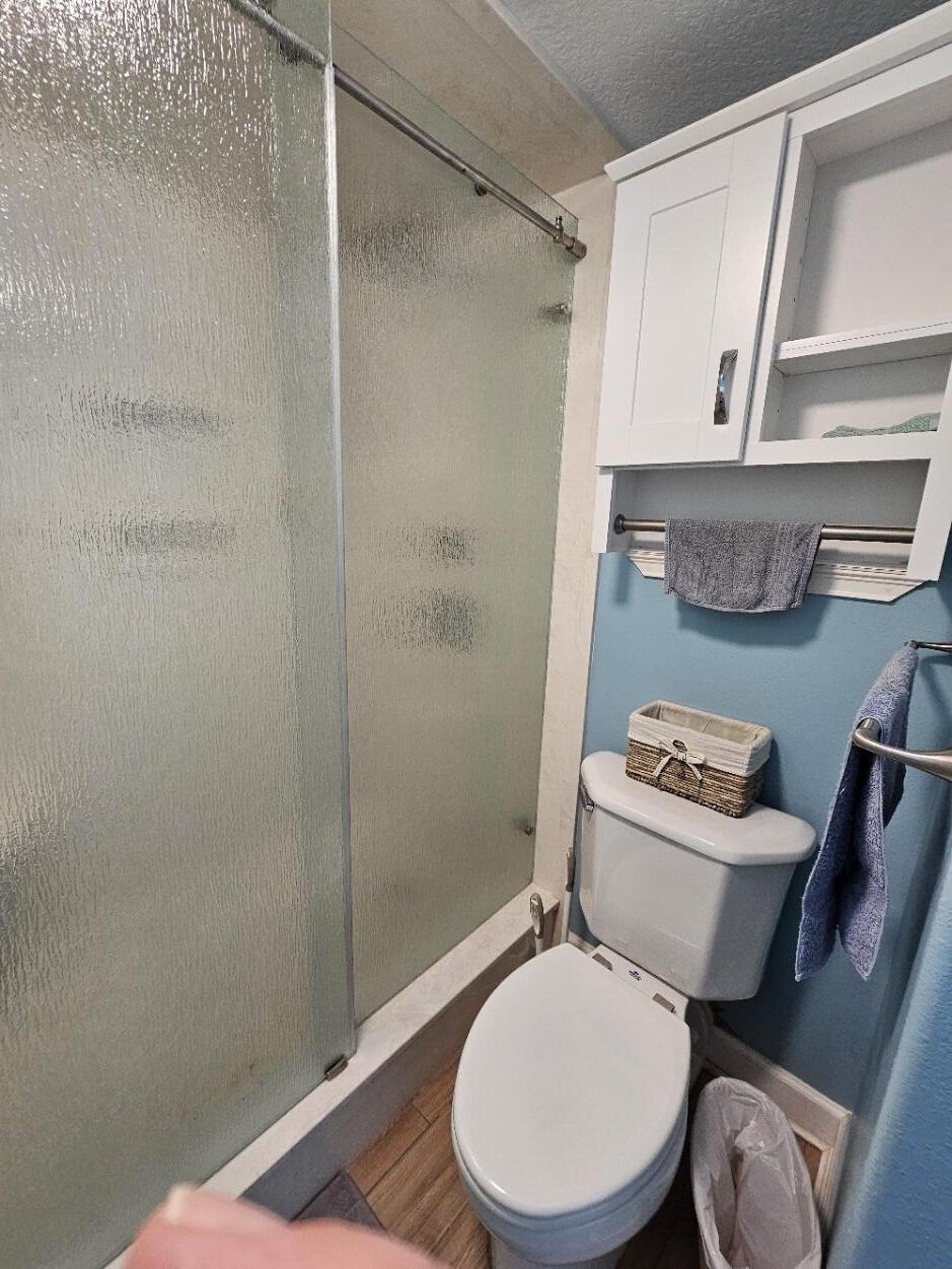 909 Santa Rosa Boulevard, Unit 229 Fort Walton Beach, FL 32548 - Photo 26 of 36 a white toilet sitting next to a shower