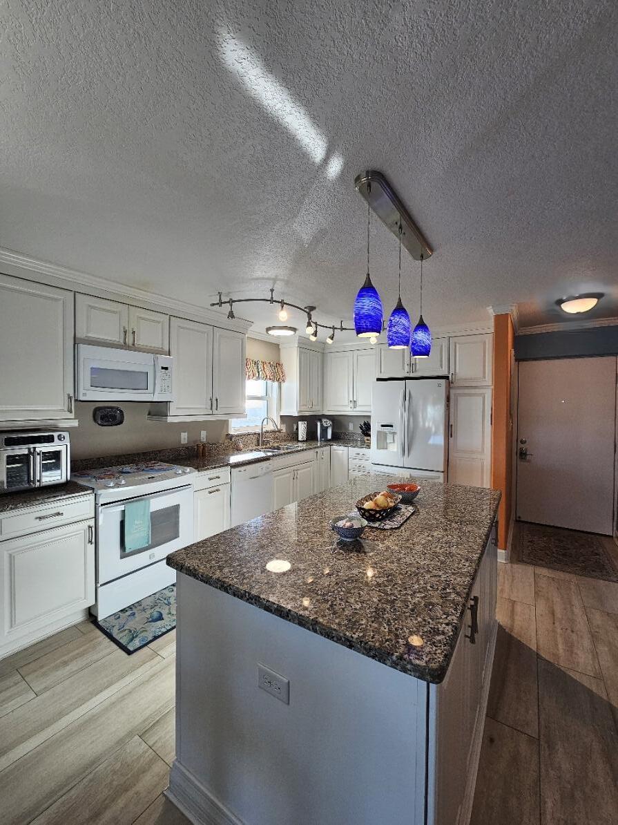 909 Santa Rosa Boulevard, Unit 229 Fort Walton Beach, FL 32548 - Photo 4 of 36 a kitchen with stainless steel appliances granite countertop a sink dishwasher and cabinets with wooden floor