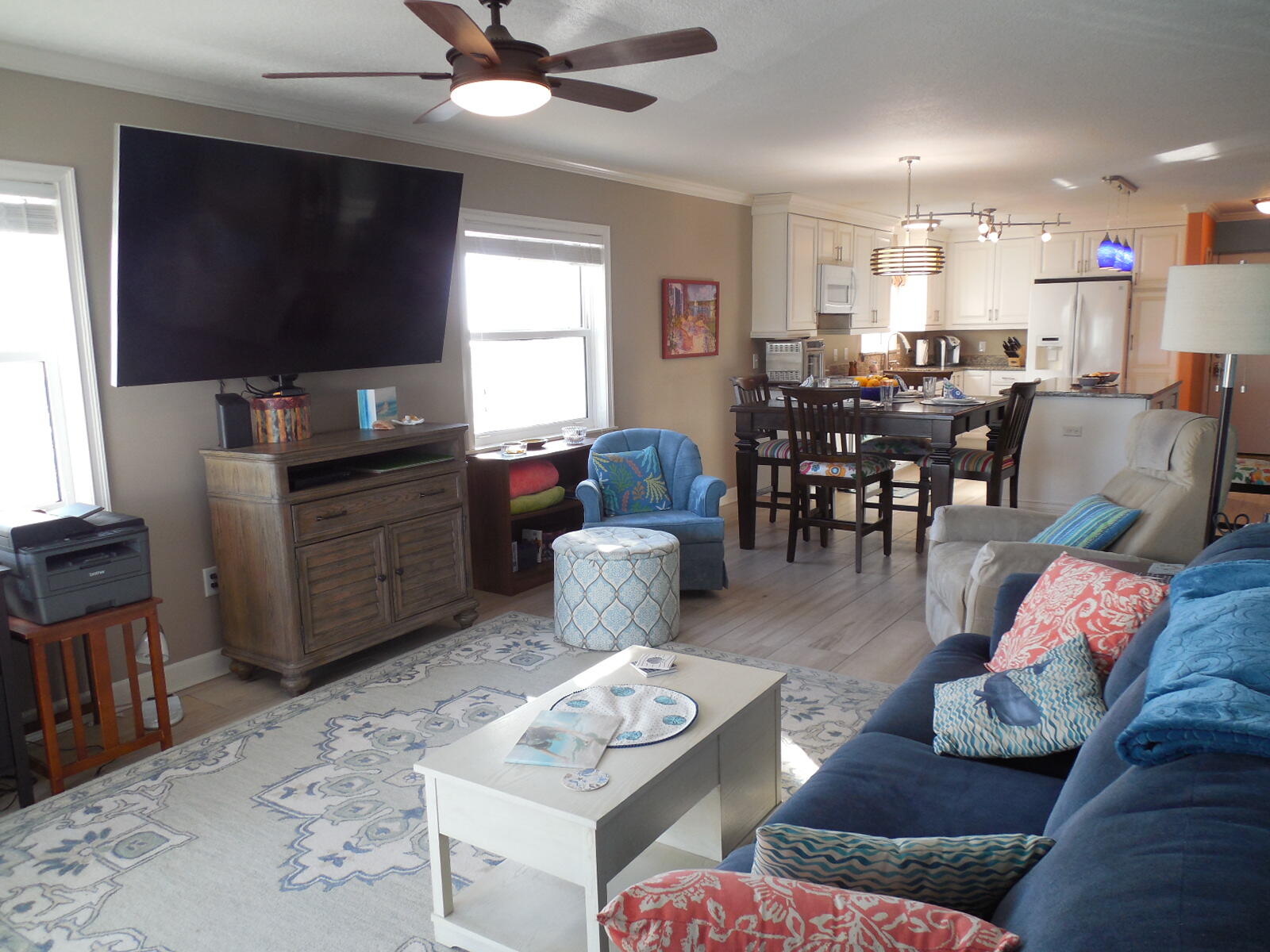 909 Santa Rosa Boulevard, Unit 229 Fort Walton Beach, FL 32548 - Photo 10 of 36 a living room with furniture a flat screen tv and kitchen view