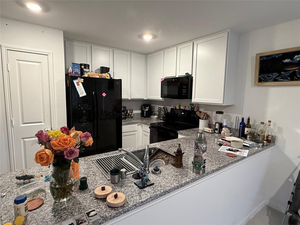 330 Ashbrook Way Princeton, TX 75407 - Photo 5 of 11 a kitchen with stainless steel appliances granite countertop a sink refrigerator and microwave