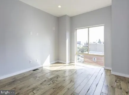 a view of hallway with wooden floor