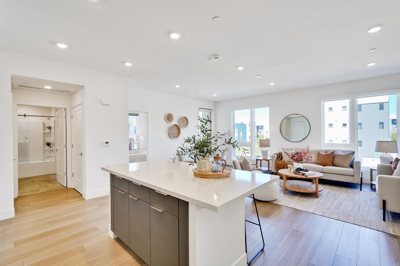 3698 Vision Common, Unit 221 Fremont, CA 94538 - Photo 15 of 62 a view of a kitchen and dining room with wooden floor