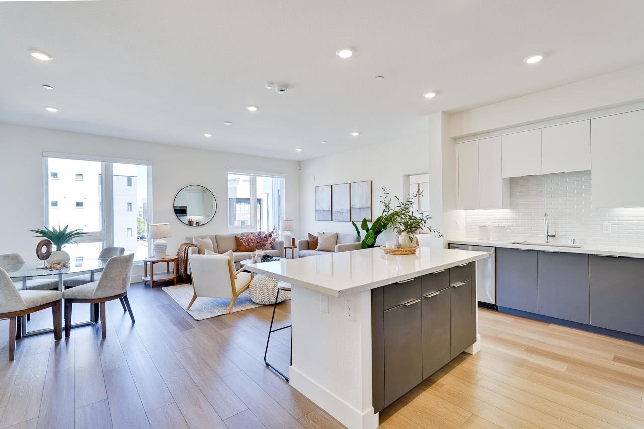 3698 Vision Common, Unit 221 Fremont, CA 94538 - Photo 16 of 62 a very nice looking open dining room with kitchen island wooden floor and stainless steel appliances