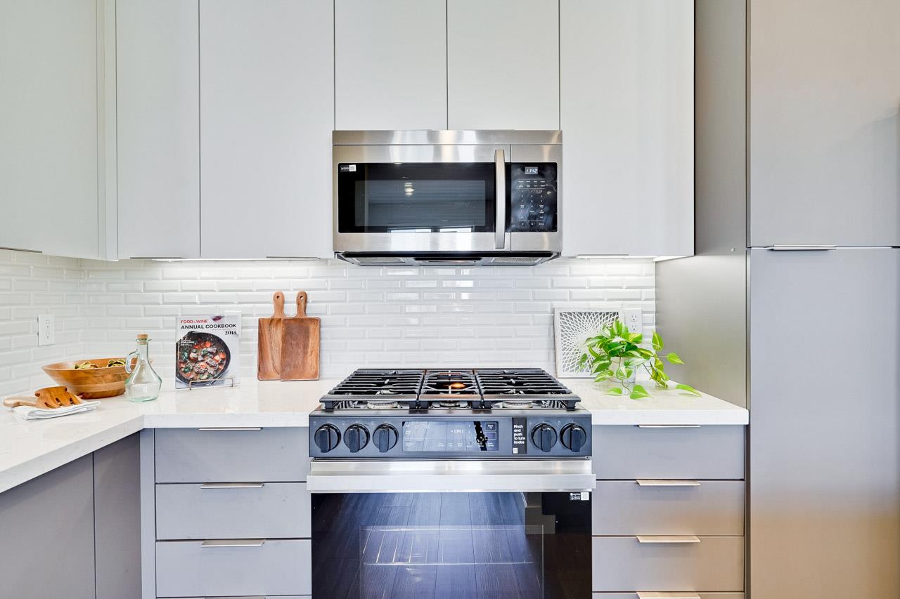 3698 Vision Common, Unit 221 Fremont, CA 94538 - Photo 18 of 62 a kitchen with a stove and microwave