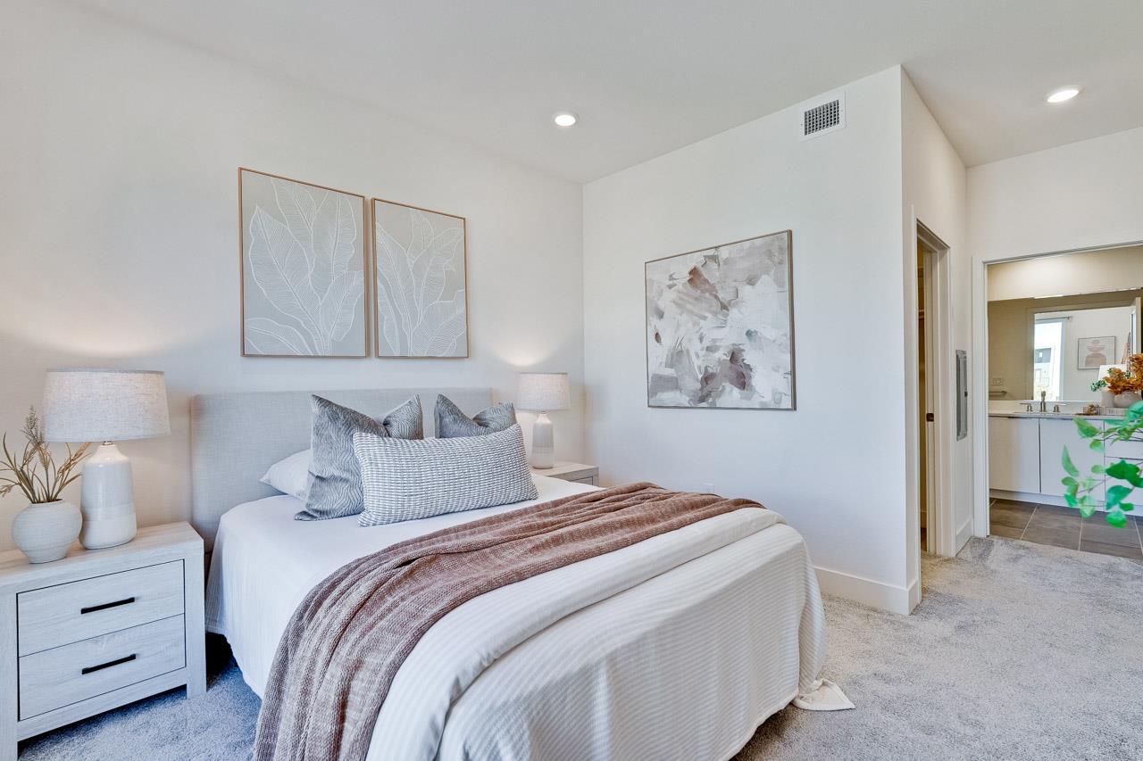 3698 Vision Common, Unit 221 Fremont, CA 94538 - Photo 20 of 62 a bedroom with a bed and a painting on the wall