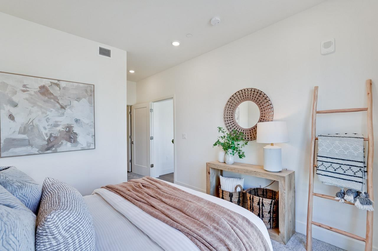 3698 Vision Common, Unit 221 Fremont, CA 94538 - Photo 21 of 62 a bedroom with a bed and a chandelier