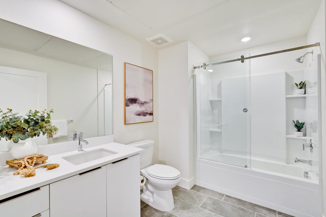 3698 Vision Common, Unit 221 Fremont, CA 94538 - Photo 32 of 62 a bathroom with a granite countertop sink a toilet and shower