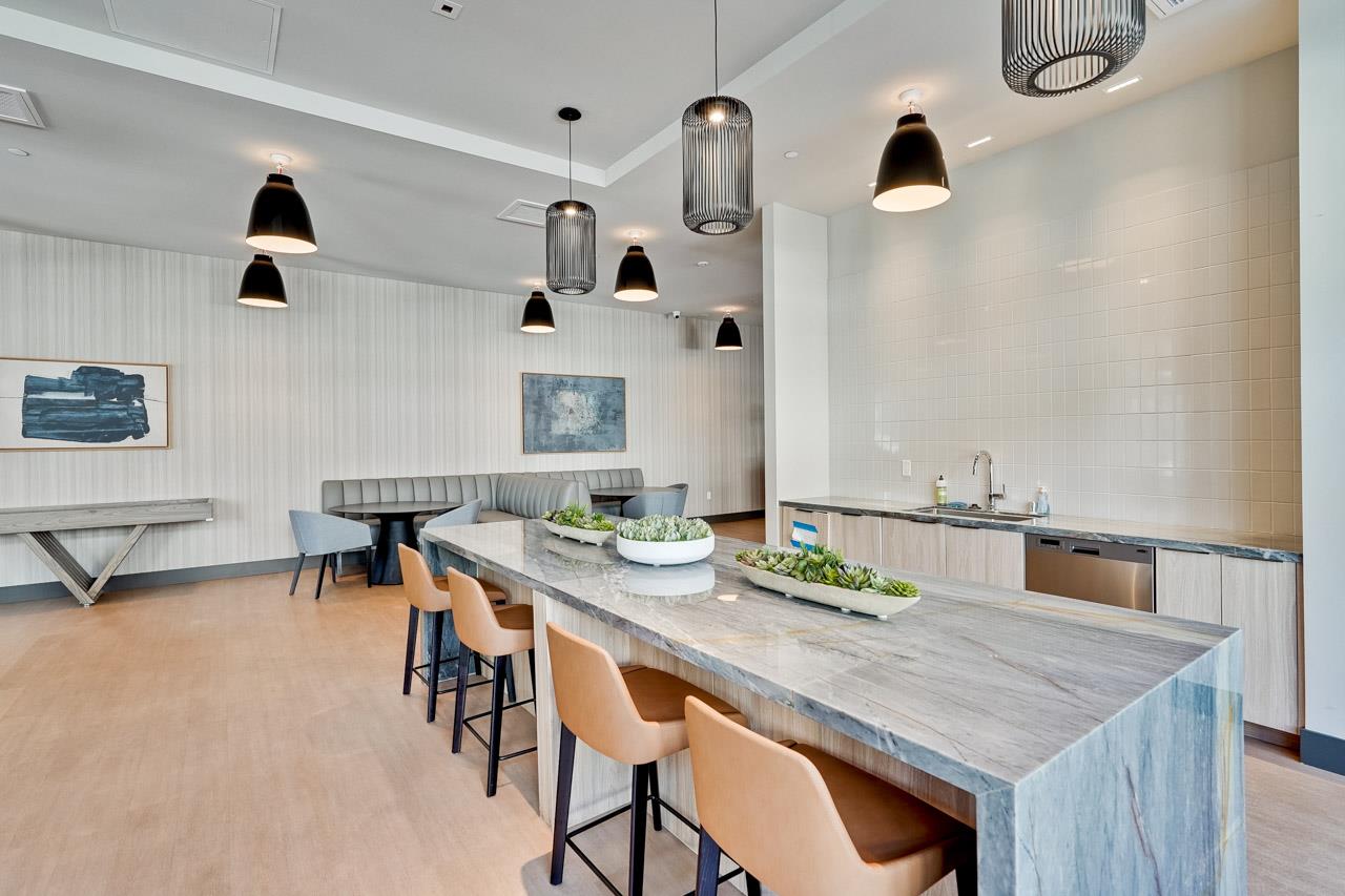 3698 Vision Common, Unit 221 Fremont, CA 94538 - Photo 50 of 62 a dining room with stainless steel appliances kitchen island a table and chairs in it