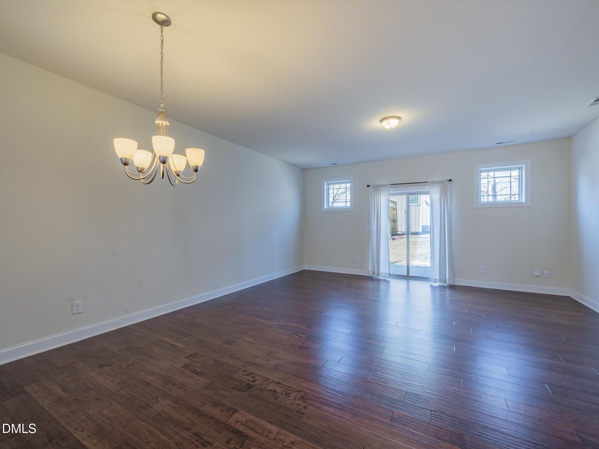 2808 Piedmont River Way Raleigh, NC 27606 - Photo 11 of 28 a view of a room with wooden floor and windows