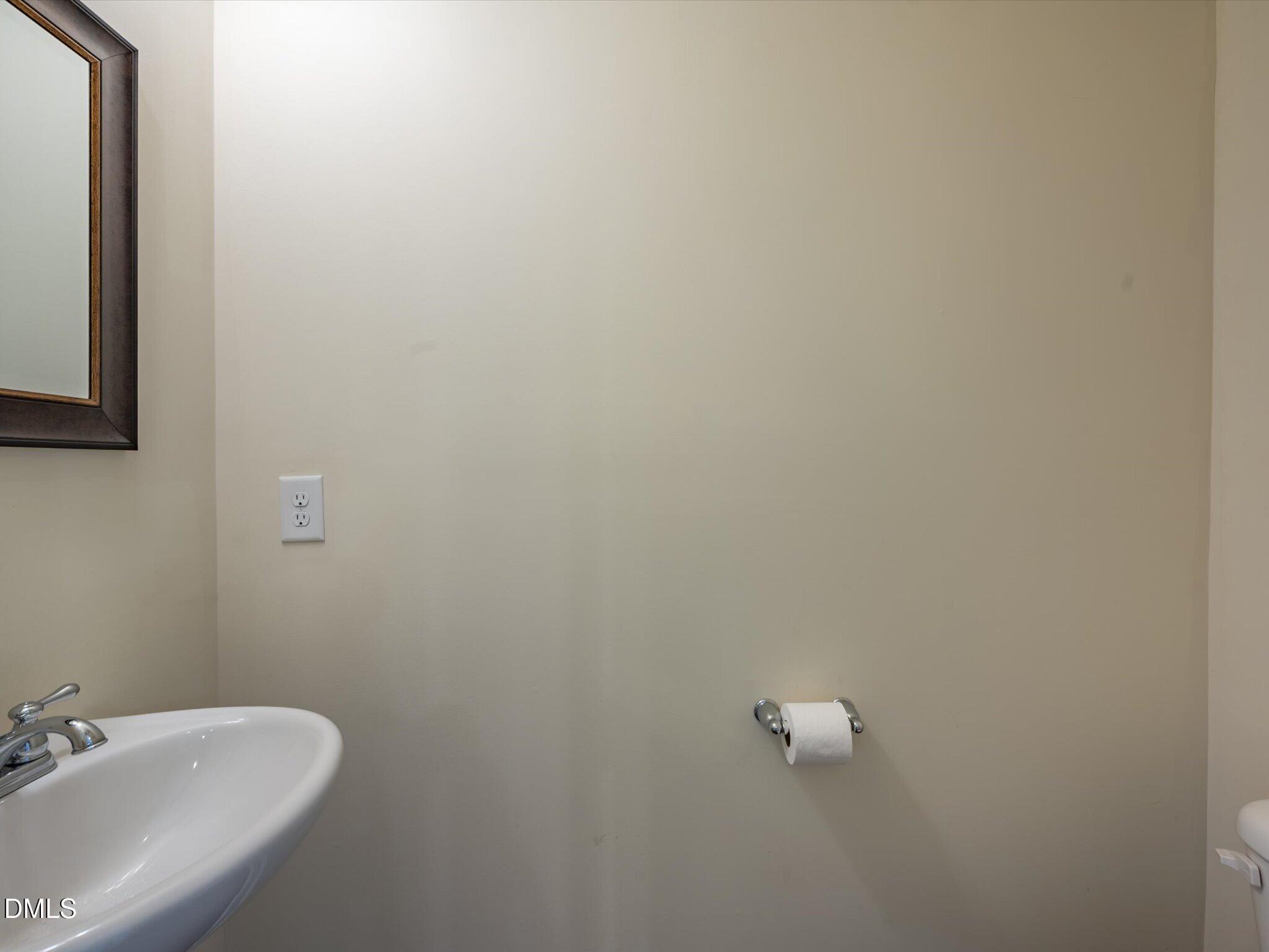 2808 Piedmont River Way Raleigh, NC 27606 - Photo 16 of 28 a bathroom with a white sink and vanity