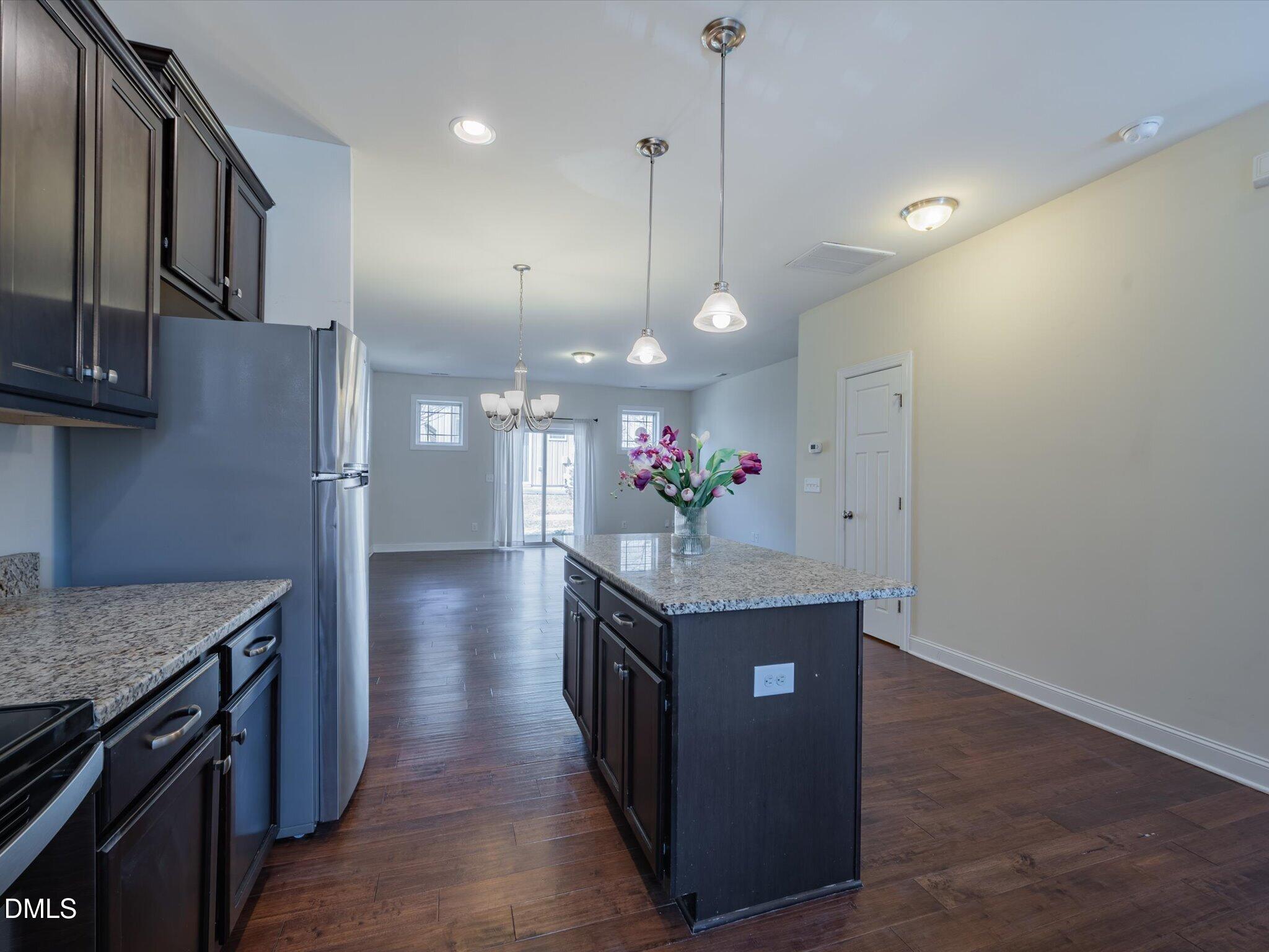 2808 Piedmont River Way Raleigh, NC 27606 - Photo 8 of 28 a view of a kitchen cabinets and chandelier