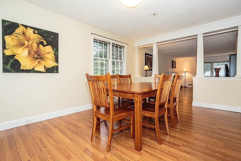 10 Marina Road Chelmsford, MA 01824 - Photo 3 of 30 a view of a dining room with furniture wooden floor and painting on the wall