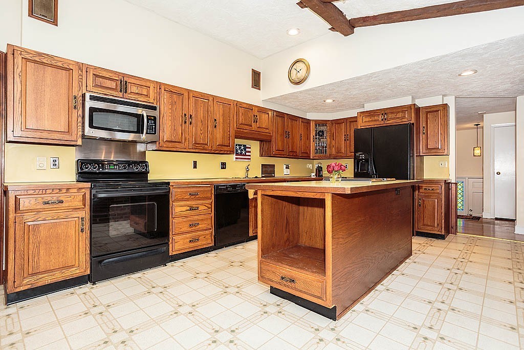 10 Marina Road Chelmsford, MA 01824 - Photo 5 of 30 a kitchen with stainless steel appliances granite countertop a stove top oven and cabinets