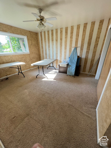 108 South Road Montpelier, ID 83254 - Photo 23 of 36 Unfurnished room with carpet, wallpapered walls, and ceiling fan