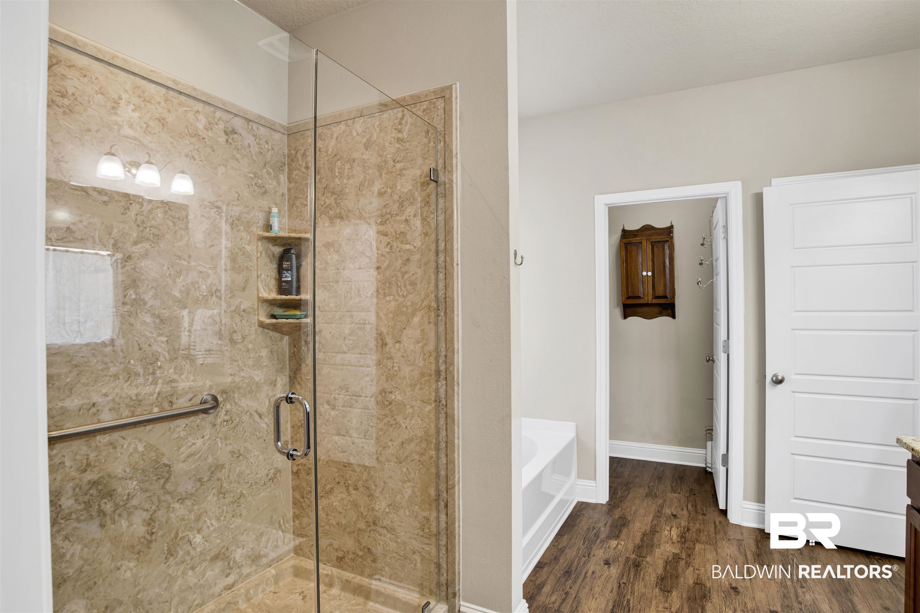 278 Silo Loop Fairhope, AL 36532 - Photo 13 of 26 Bathroom with a garden tub, a stall shower, and wood finished floors