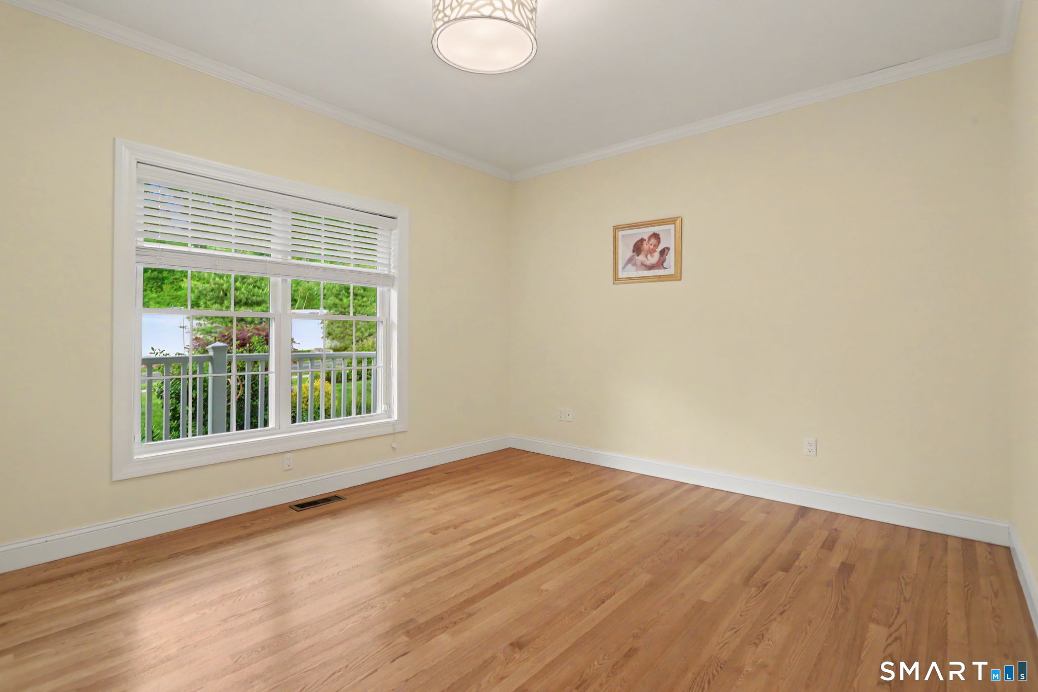 223 Meadow Brook Road, Unit 223 Oxford, CT 06478 - Photo 20 of 34 a view of empty room with wooden floor and fan