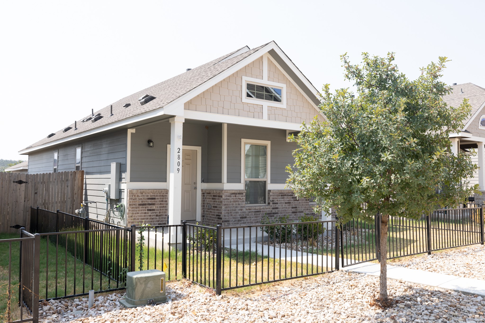 a front view of a house with a garden