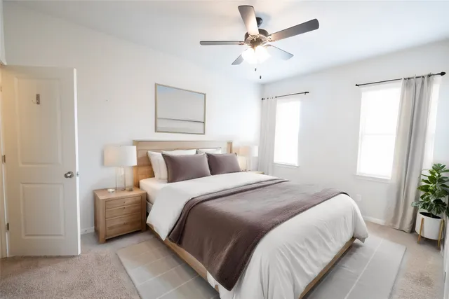 a bedroom with bed and a window