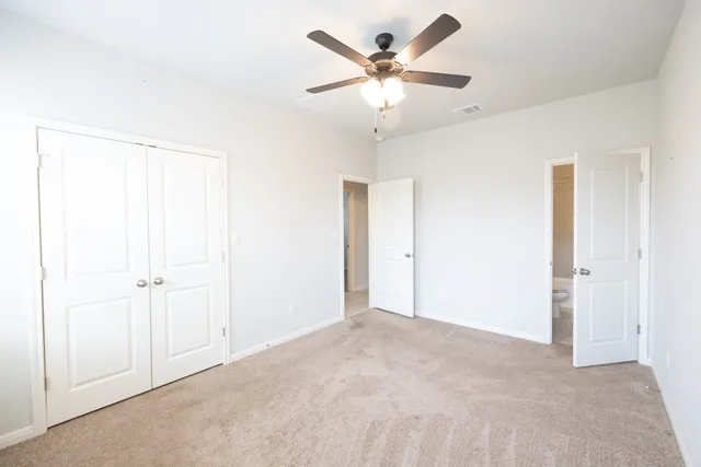 an empty room with a ceiling fan