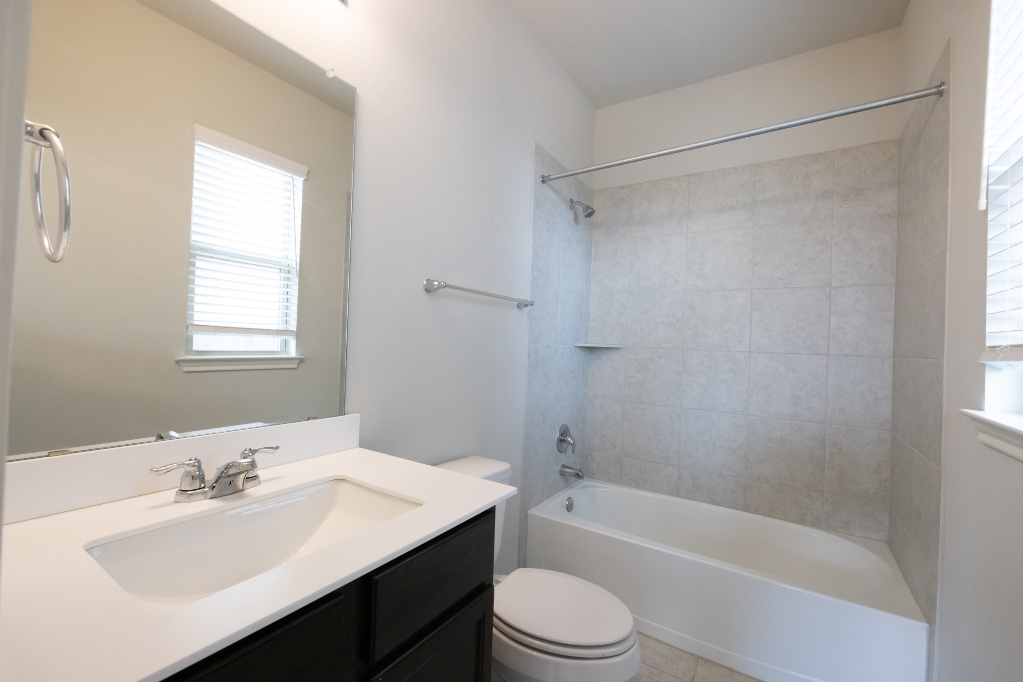 2809 Seneca Path, Unit 30 Leander, TX 78641 - Photo 24 of 30 a bathroom with a bathtub shower sink vanity mirror and toilet