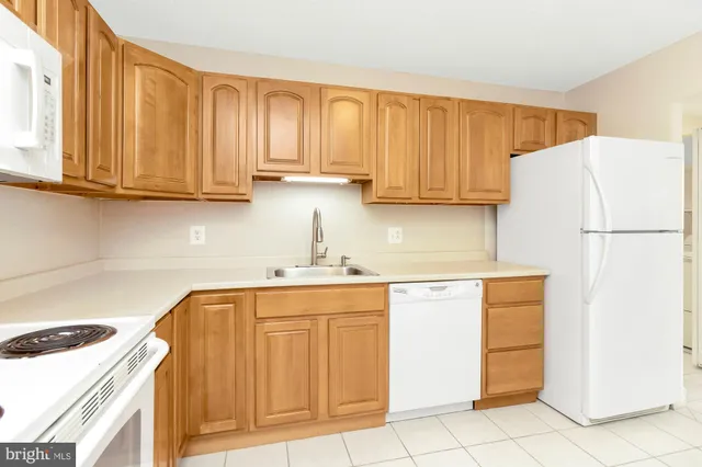 a kitchen with stainless steel appliances granite countertop a refrigerator sink and cabinets
