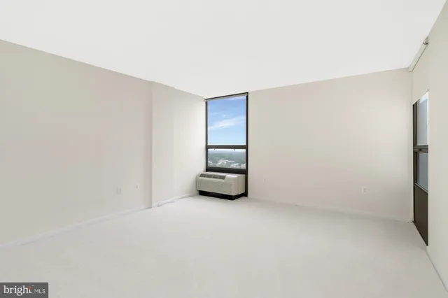 a view of a livingroom with an empty space and a window