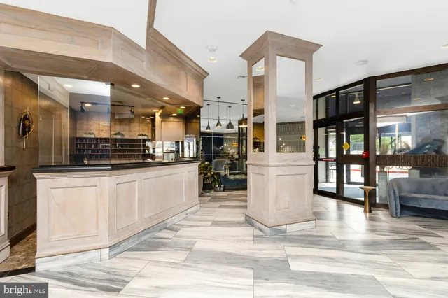 a view of a kitchen with stainless steel appliances kitchen island granite countertop a refrigerator and cabinets