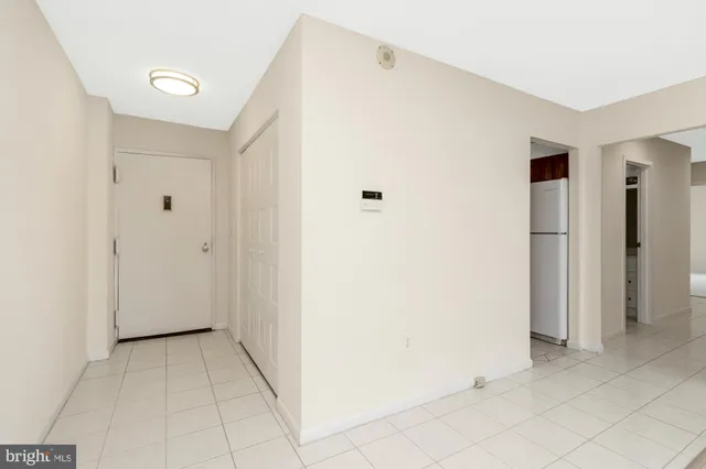 an empty room with windows and ceiling fan