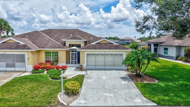 a front view of a house with a garden and plants