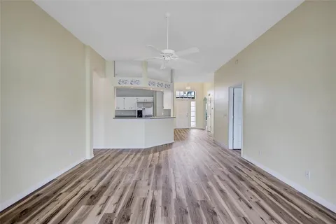 a view of a kitchen with wooden floor and a kitchen