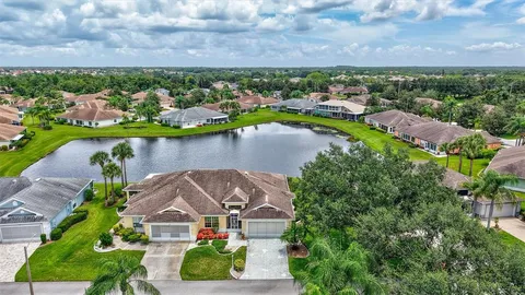 an aerial view of a house with a lake view
