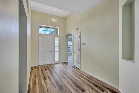 a view of a room with wooden floor and windows