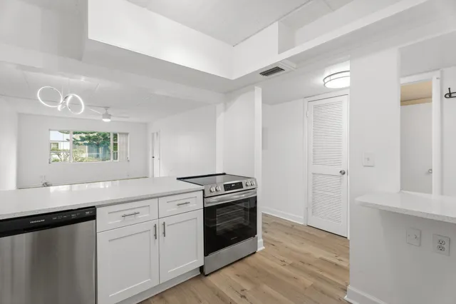 a kitchen with a stove microwave and sink