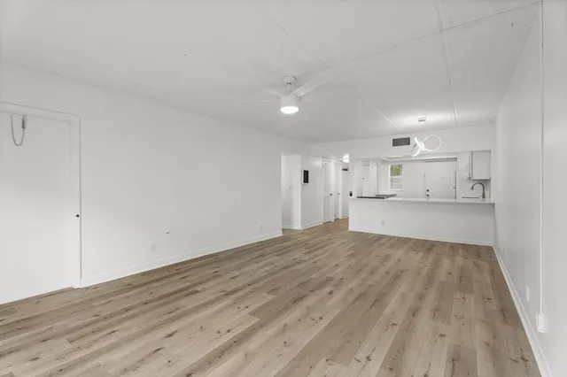 a view of a kitchen with wooden floor