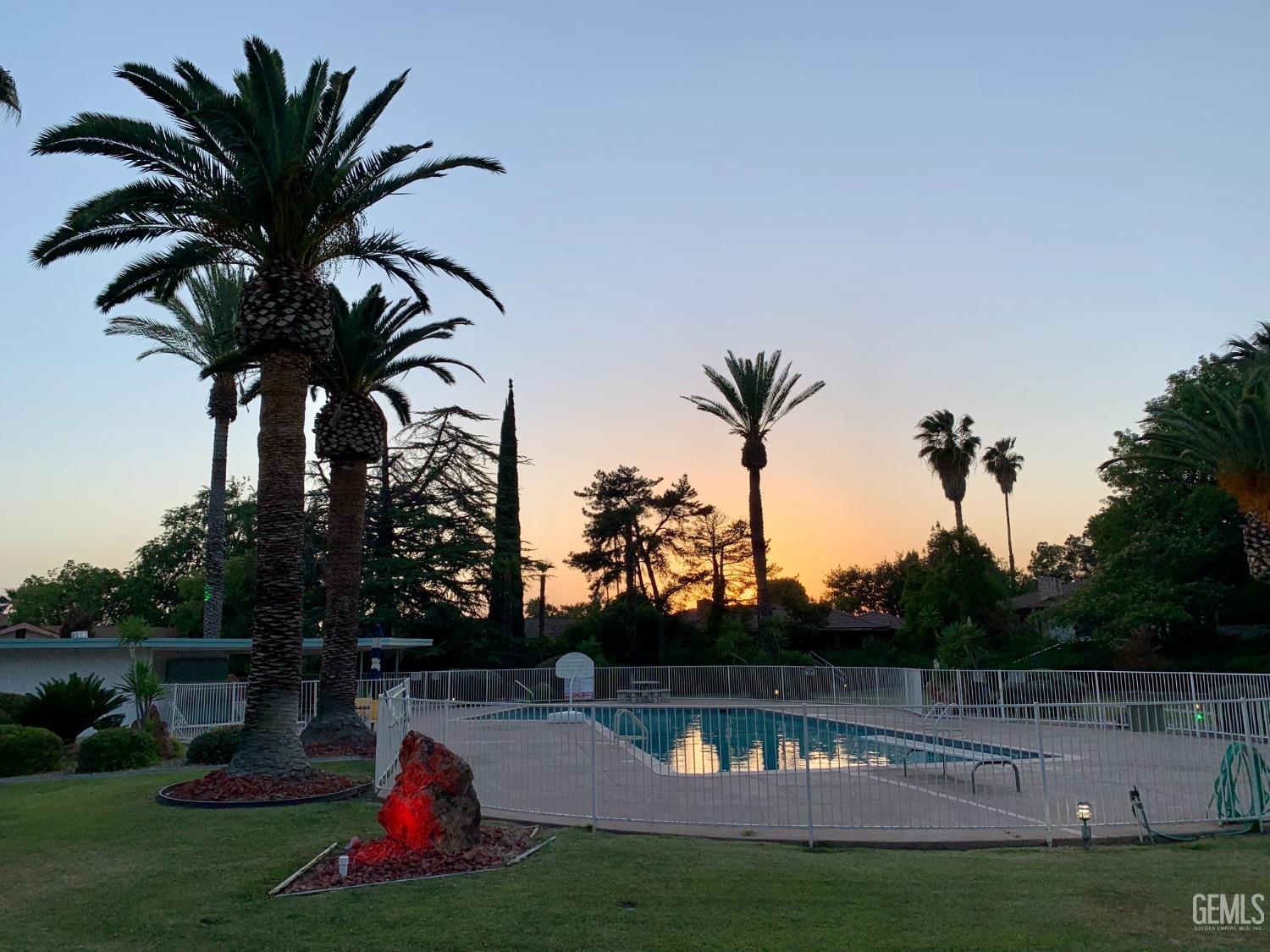 Undisclosed Address Bakersfield, CA 93306 - Photo 29 of 34 a view of a swimming pool with a table and chairs