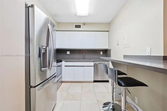 a kitchen with a stove microwave and refrigerator