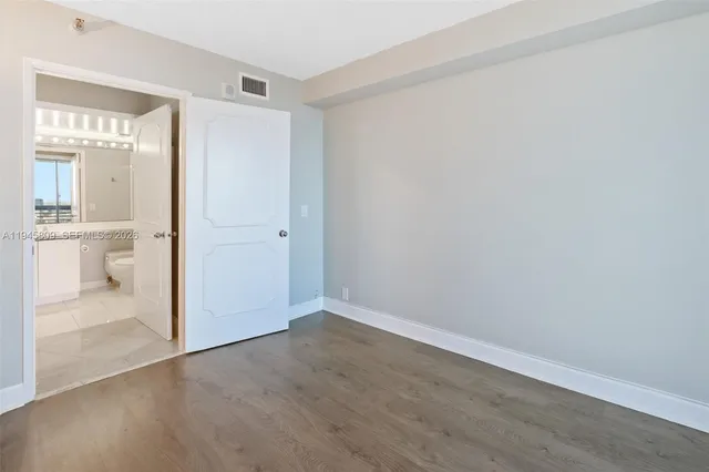 a bathroom with a shower sink vanity mirror and toilet