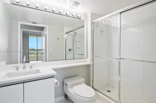 a bathroom with a mirror and a shower