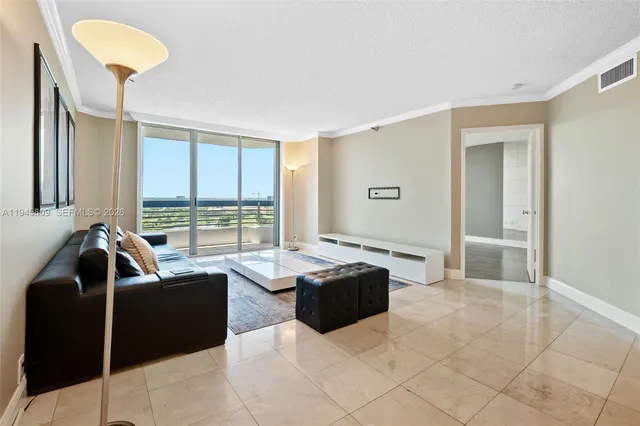 a living room with furniture and a floor to ceiling window