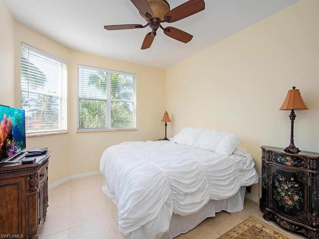 6537 Marissa Loop, Unit 10 Naples, FL 34108 - Photo 12 of 15 a bedroom with a bed and a window