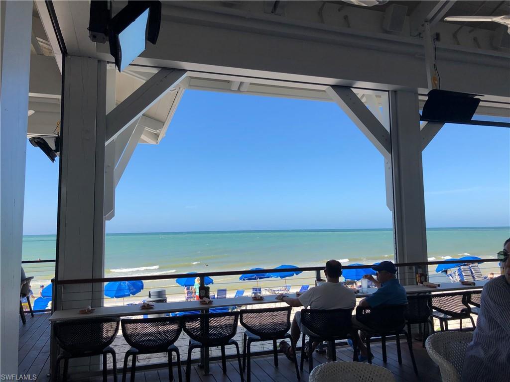 6537 Marissa Loop, Unit 10 Naples, FL 34108 - Photo 14 of 15 a view of a dining room with furniture and wooden floor