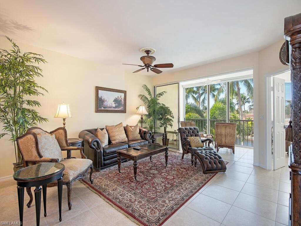 6537 Marissa Loop, Unit 10 Naples, FL 34108 - Photo 4 of 15 a living room with furniture a table and a large window