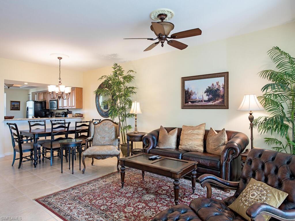 6537 Marissa Loop, Unit 10 Naples, FL 34108 - Photo 5 of 15 a living room with furniture and a wooden floor