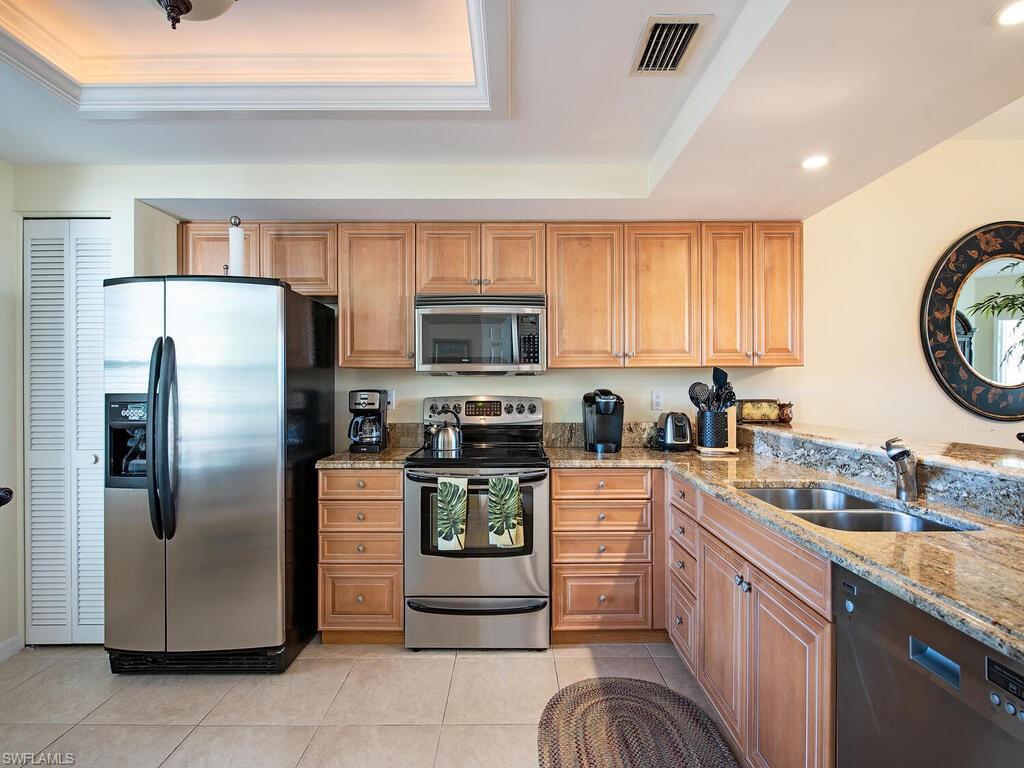 6537 Marissa Loop, Unit 10 Naples, FL 34108 - Photo 7 of 15 a kitchen with a refrigerator sink and microwave