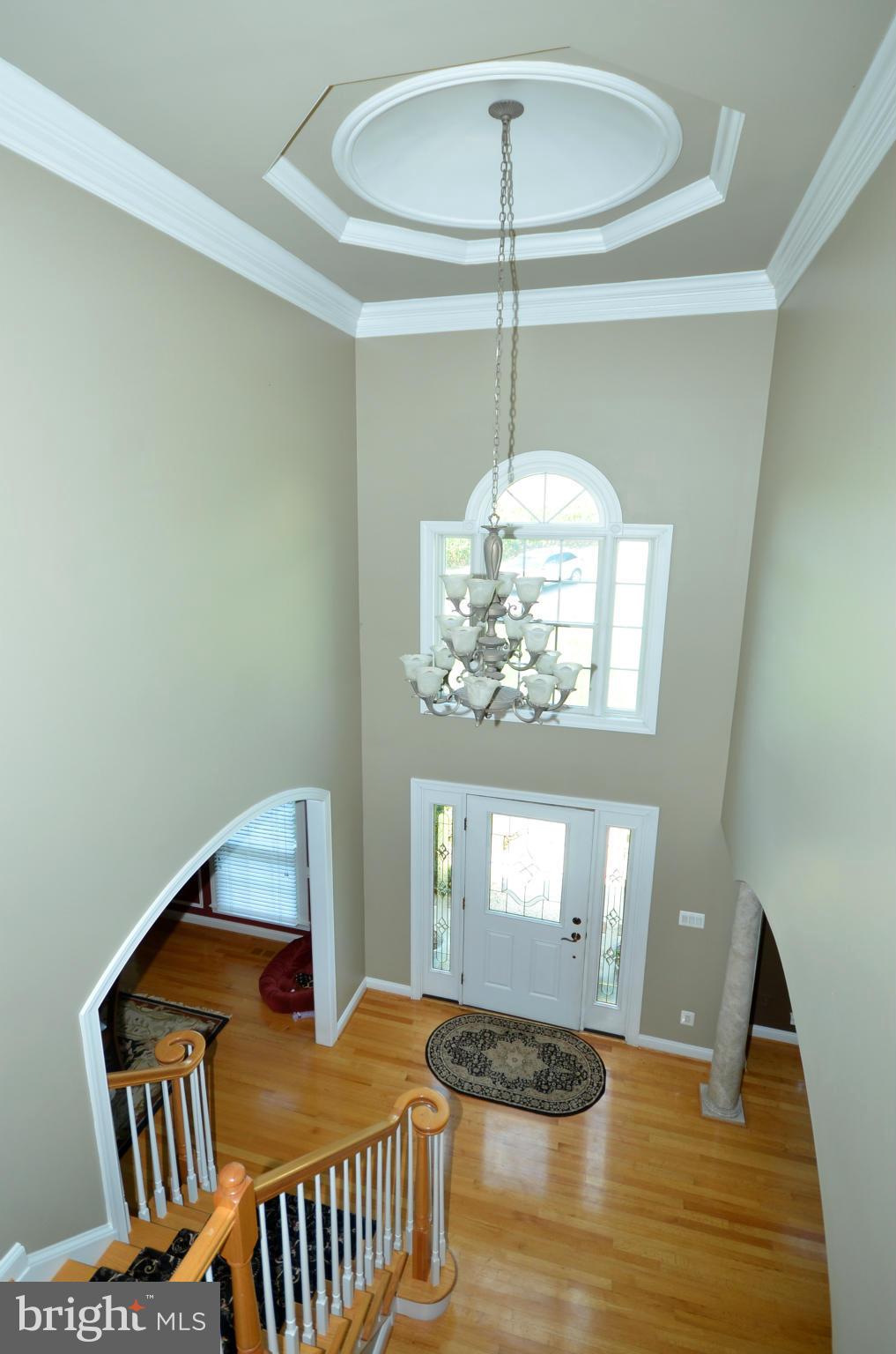 3401 Meredith Ridge Road Phoenix, MD 21131 - Photo 2 of 28 a bedroom with a bed and chandelier